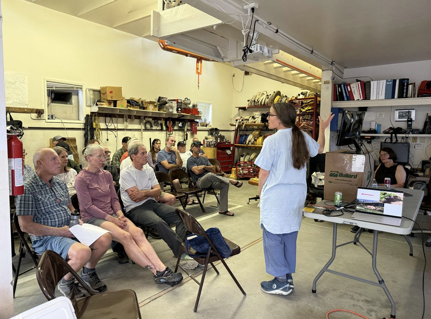 Neighbors at the June kickoff meeting at the fire station learning about high fire risk plants